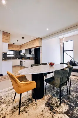 a kitchen and dining room with a table and chairs at Phoenix Home in Cape Town