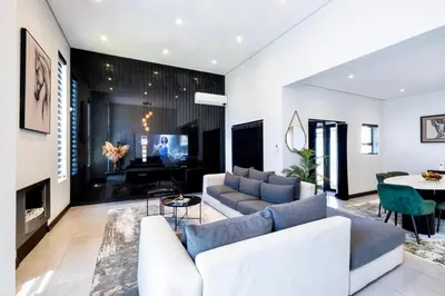 a living room with a couch and a table at Phoenix Home in Cape Town