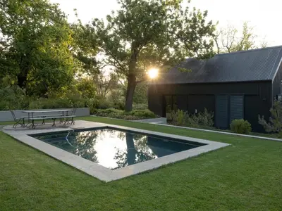 a backyard with a pool and a picnic table at Farm Keerweer in Stellenbosch
