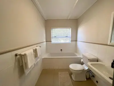 a bathroom with a tub and a toilet and a sink at Views galore in Kleinmond in Kleinmond