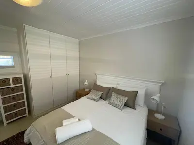 a bedroom with a white bed with two pillows at Views galore in Kleinmond in Kleinmond