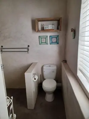 a small bathroom with a toilet and a sink at Chillilabombwe in Pringle Bay