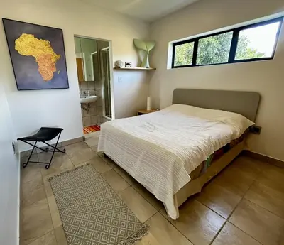 a bedroom with a bed and a window at Happy Place Pringle Bay in Pringle Bay