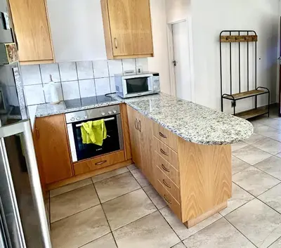 a kitchen with a counter and a stove top oven at Happy Place Pringle Bay in Pringle Bay