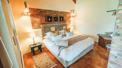 a bedroom with a large bed in a room at Villa Chad Luxury Guesthouse in Kleinmond