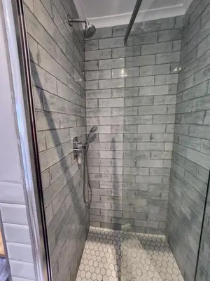 a shower with a glass door in a bathroom at Rocky Bay on the View in Gordonʼs Bay
