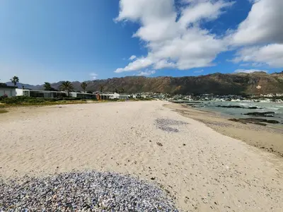 a view of the beach with mountains in the background at Seaside Charm in Gordonʼs Bay