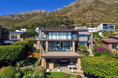 an aerial view of a house with a mountain at Zaria Sun Cottage in Gordonʼs Bay