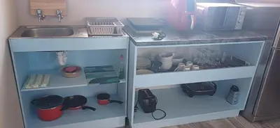 a kitchen with a sink and a cabinet with dishes at Dukes Place in Hermanus