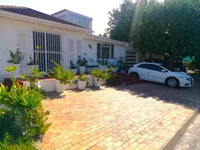 a white car parked in front of a house at 11 on Orange in Cape Town