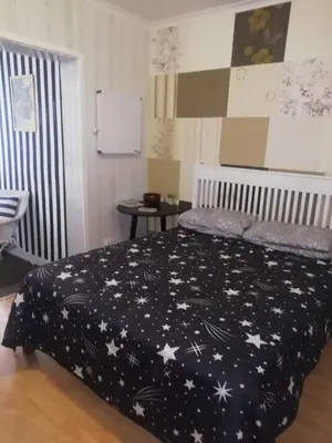 a bedroom with a black comforter with stars on it at 11 on Orange in Cape Town