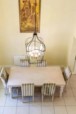 a dining room table with chairs and a chandelier at The hidden Retreat on Haumann in Franschhoek
