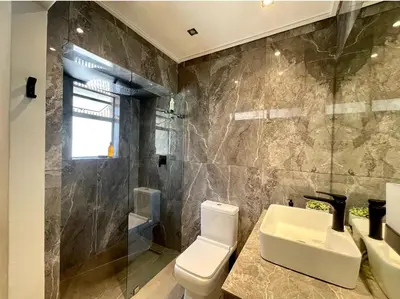 a bathroom with a toilet and a sink and a shower at Modern Flat in the Cape Winelands in Stellenbosch