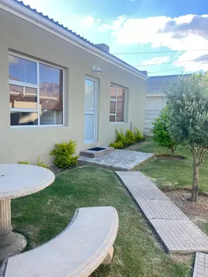 a house with a patio and a table in the yard at Olive Tree in Worcester