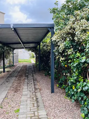 a covered walkway with a black roof at Olive Tree in Worcester