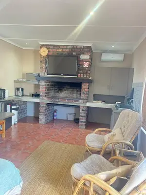 a living room with a fireplace with a flat screen tv at Olive Tree in Worcester