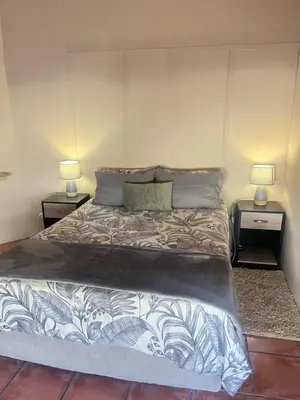 a bedroom with a large bed with two night stands at Olive Tree in Worcester