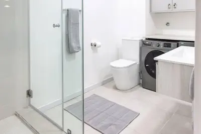 a bathroom with a shower and a toilet and a sink at Tranquil Loft Design and Underground Parking in Stellenbosch