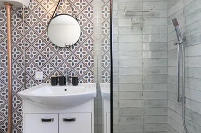 a bathroom with a sink and a mirror at Sea Spray B104 in Table View