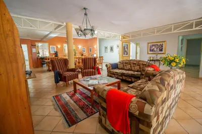 a living room with two couches and a table at Broadway Boston in Cape Town