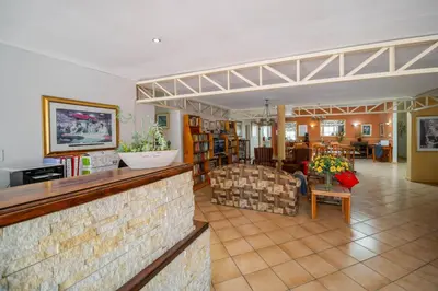 a living room with a couch and a table at Broadway Boston in Cape Town