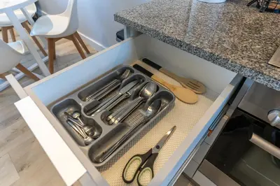 a drawer with scissors and other kitchen utensils at Burmeister 606 - Top Floor 2 Bedroom Apartment with Ocean Views - Onsite Parking in Cape Town