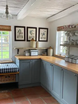 a kitchen with blue cabinets and a wooden counter top at 13 On Vigne in Greyton