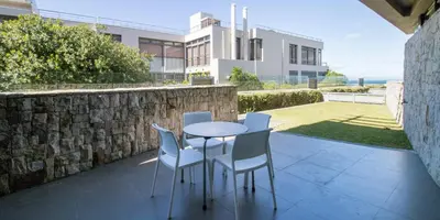 a patio with a table and chairs and a building at Harbour House Hotel - Le Paradis Apartments in Hermanus