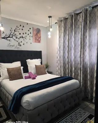 a bedroom with a large bed in a room at Elite Escape in Cape Town