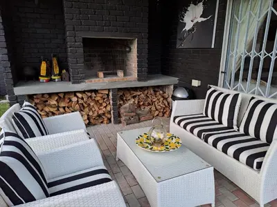 a patio with two couches and a fire place at Milky Way in Hermanus