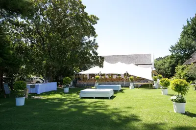 a lawn with a tent and some plants and trees at Leipzig Country House & Winery in Nuy