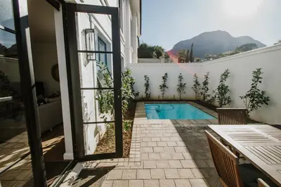 a view from the balcony of a house with a swimming pool at Quiet Hideaway in Somerset West