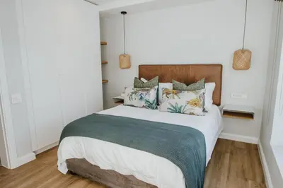a bedroom with a large bed with pillows at Quiet Hideaway in Somerset West