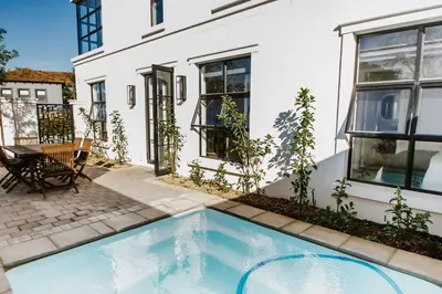 a swimming pool in the backyard of a house at Quiet Hideaway in Somerset West