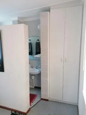 a white bathroom with a sink and a toilet at HARTSRUS in Kleinmond