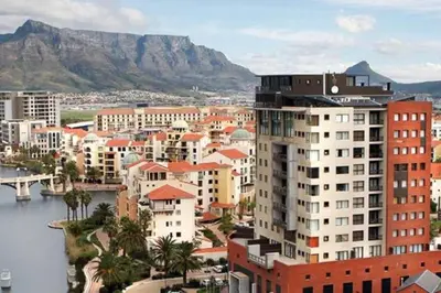 a city with buildings and a mountain in the background at Grand Penthouse / Backup Power / Stunning in Cape Town