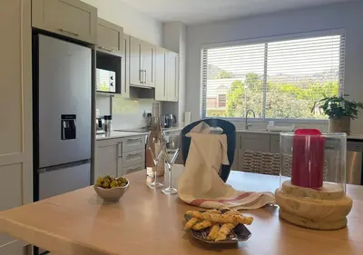 a kitchen with a wooden table with food on it at Franschhoek Mountain Views in Franschhoek