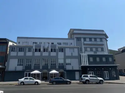 a building with three cars parked in front of it at Pepper Korrel - Paarl - Self Catering Apartment in Paarl