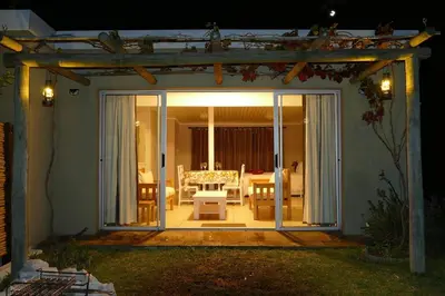 an open door to a patio with a table at Cuckoo's Corner in Bettyʼs Bay