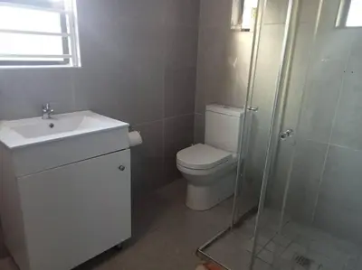 a bathroom with a toilet and a sink and a shower at Two bedroom flatlet in Panorama in Cape Town