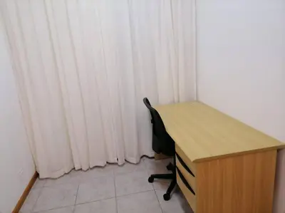a desk and a chair in a room with curtains at Two bedroom flatlet in Panorama in Cape Town