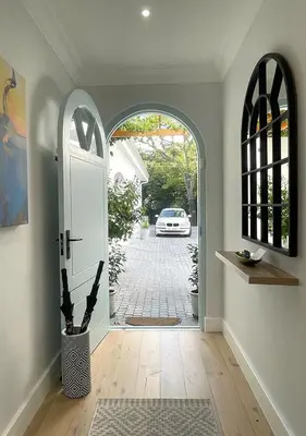 an open door to a driveway with a car outside at 2 Riverside Oaks in Franschhoek