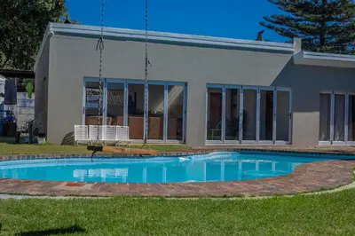 a swimming pool in front of a house at Meah lane , TableView in Cape Town