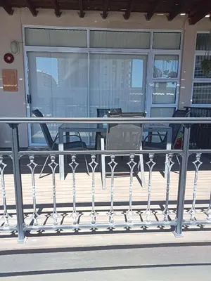 a railing on a balcony with a table at Culemborg Court in Cape Town