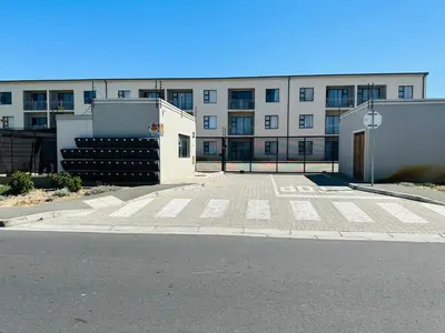 an empty parking lot in front of a building at Delightful Retreat in Parklands,Cape Farms,Cape Town in Cape Town