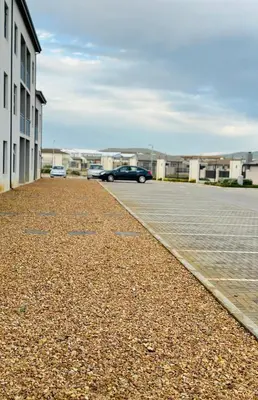 a parking lot with cars parked in front of buildings at Delightful Retreat in Parklands,Cape Farms,Cape Town in Cape Town