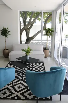a living room with a couch and a table at Digital Nomad's Nest, Somerset West in Cape Town