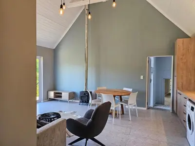 a kitchen and dining room with a table and chairs at Die Heerenhuys Guest Suites in Stellenbosch