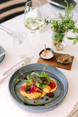 a plate of food on a table with wine glasses at Endless Vineyards at Wildekrans Wine Estate in Botrivier