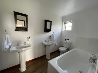 a bathroom with two sinks and a tub and a toilet at Endless Vineyards at Wildekrans Wine Estate in Botrivier